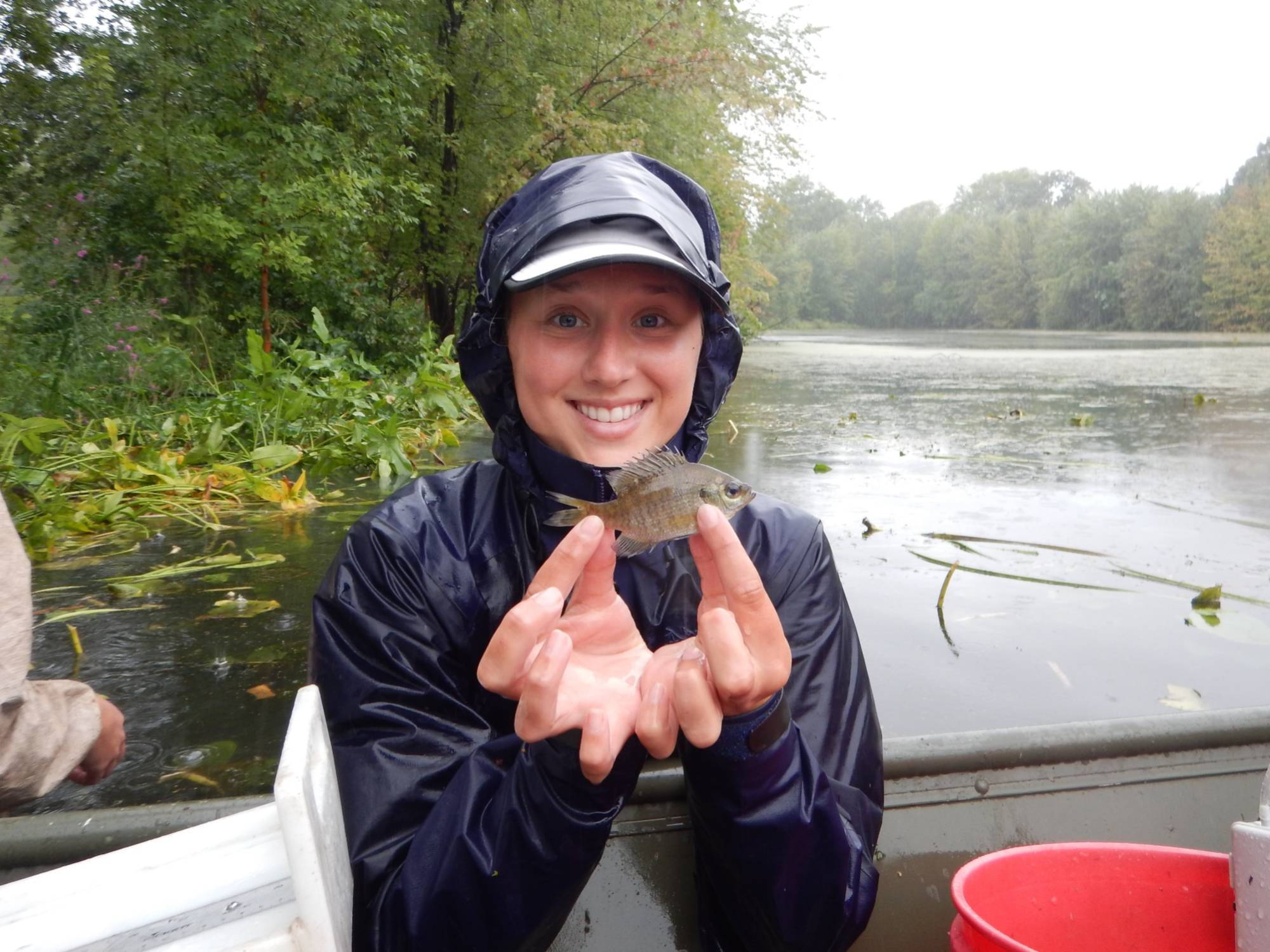 Maria displays a bluegill for the camera.